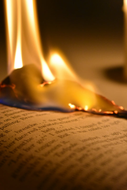 lighted candle on white paper