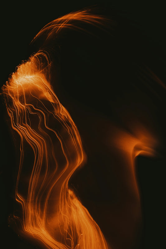 A blurry image of a woman's face with orange hair