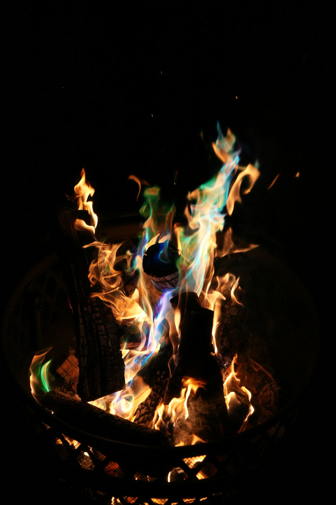 Colorful flames burn brightly in the night.