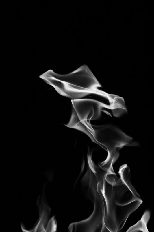 White smoke rises against a black background.