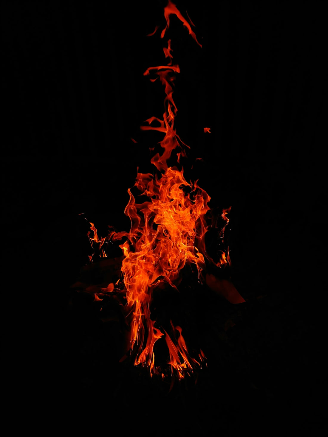Flames dance against a stark black background.
